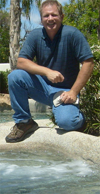 Kyle Elliott beside a swimming pool